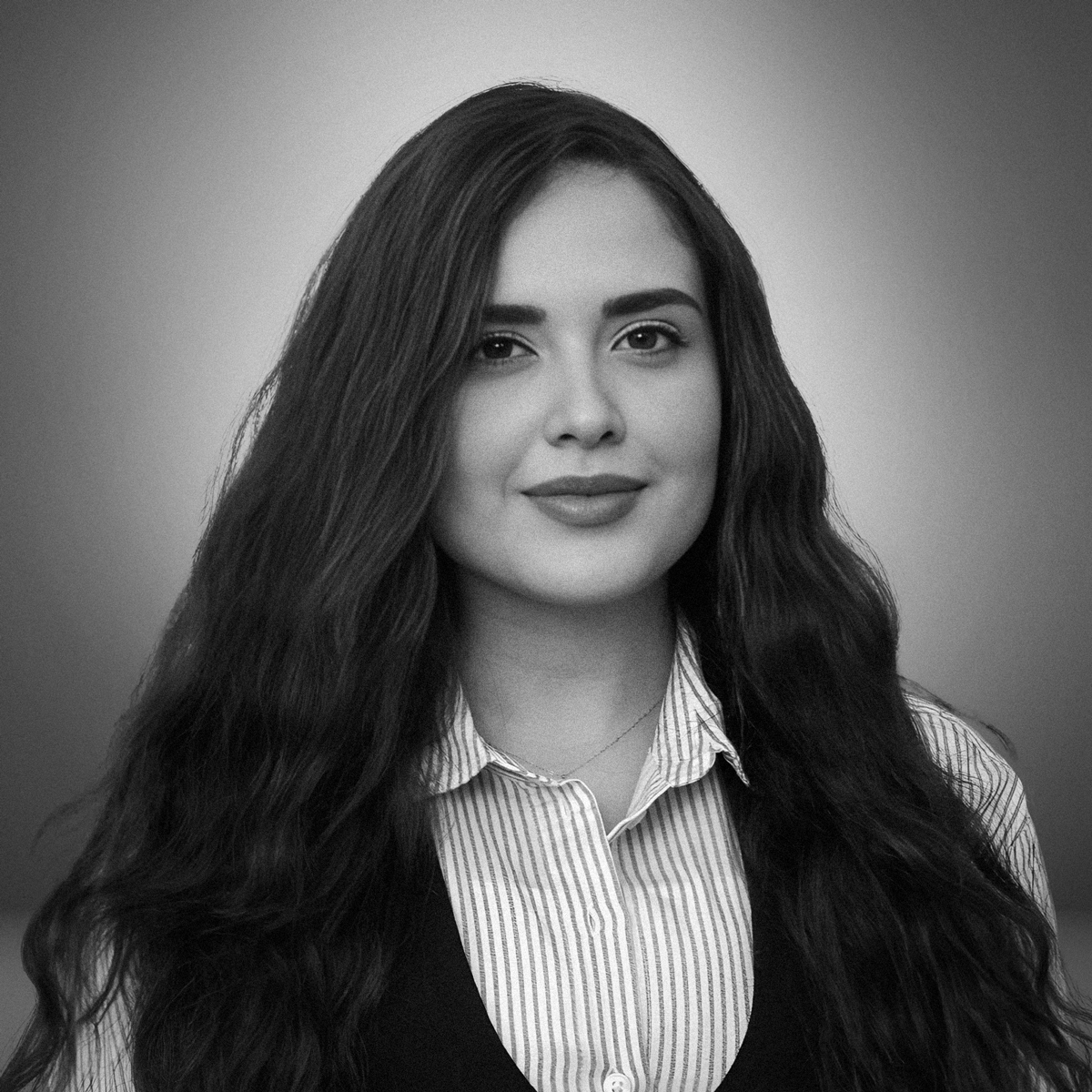 Nourhan Abdelsalam: Portrait of Nourhan Abdelsalam, Talent Acquisition Specialist at Creative Hospitality, in business attire with long wavy hair, looking at the camera with a slight smile.